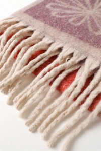 Macro detail of vintage floral cashmere-like scarf showing texture and fringe edge