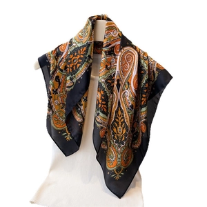 Exotic paisley printed faux silk square scarf featuring vibrant patterns on black fabric