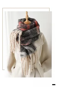 Detailed close-up of rainbow plaid cashmere scarf with soft tassels and grey-red patterns