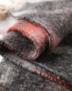 Macro texture of soft rainbow plaid cashmere shawl with detailed fringe stitching
