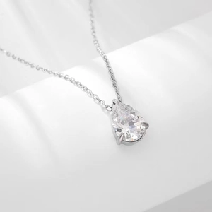 Macro view of water-drop cubic zirconia pendant on a silver-tone necklace chain