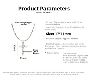 Macro detail of silver cross pendant with heart zircon, showing 17x11mm dimensions