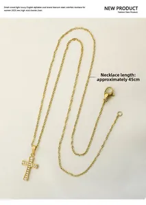 Close-up of golden cross necklace with zircons and 45cm titanium steel chain details