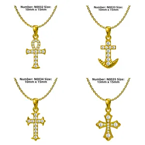 Macro display of four gold-plated cross pendants with cubic zirconia and dimensions
