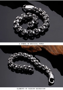 Close-up of punk style skull link bracelet with detailed engravings and metal clasp