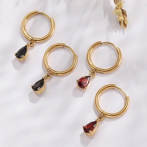 Detailed shot of teardrop zircon earrings in black and red on a white fabric background