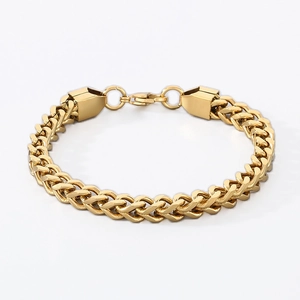 Close-up of gold wheat chain bracelet with polished cylindrical ends and lobster clasp