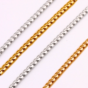 Detailed macro view of silver and gold plated stainless steel box chains with metallic luster