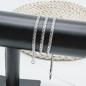 Detail of silver stainless steel box chain necklace with lobster clasp on display