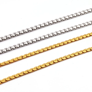 Polished stainless steel gold and silver box chain necklaces on white background