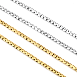 Close-up of interlocking gold and silver stainless steel square link chains for jewelry