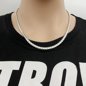 Minimalist silver stainless steel box chain necklace worn on model for modern style