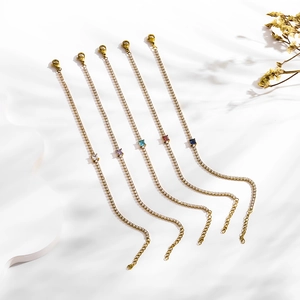 Detail of five gold tennis bracelets with colorful rectangular zircons and lobster clasp