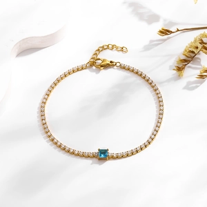 Gold tennis bracelet with blue square zircon centerpiece and sparkling pavé setting