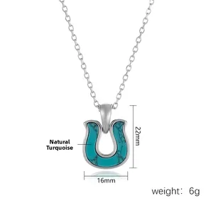 Detail view of horseshoe turquoise pendant measuring 16mm by 22mm on silver chain