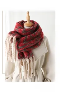 Macro detail of geometric color block cashmere-like scarf with thick tassel accents