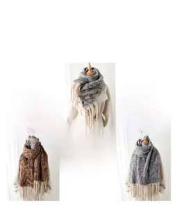 Close-up of thick geometric tassels scarves in gray and coffee colors for autumn