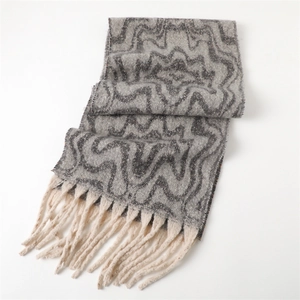 Close-up of geometric pattern cashmere-like scarf with thick off-white fringe tassels
