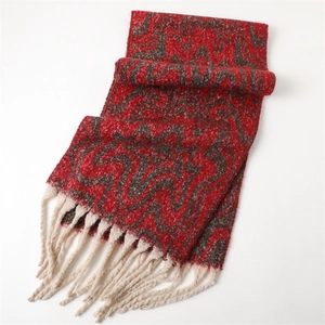 Detail of red and grey wavy pattern cashmere scarf with thick cream tassels