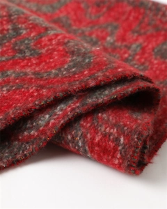 Macro view of geometric red and grey faux cashmere scarf with fine stitching details