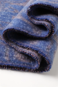 Detailed macro view of soft navy and purple cashmere-feel fabric with shimmering edges