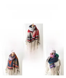 Detail of soft pashmina shawl with geometric triangle patterns and long tassel edges