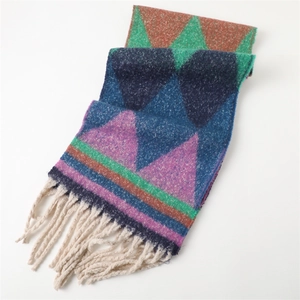 Close-up of geometric pattern and white tassels on soft pashmina shawl scarf