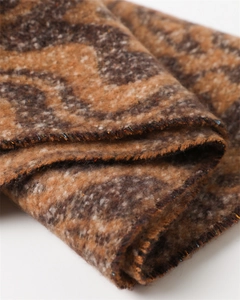 Macro detail of thick brown wavy marble pattern scarf with decorative color neps