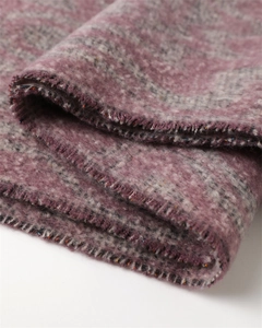 Macro shot showing purple and grey cashmere texture with colorful metallic fiber details
