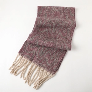 Detail of purple and grey wave knit scarf featuring thick off-white decorative tassels