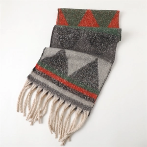 Detail of geometric triangle knit scarf with thick cream tassels and soft texture