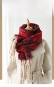 Detail of red and blue checkered winter scarf with long beige tassels on a mannequin