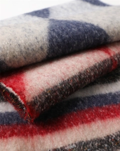 Macro shot of thick cashmere-like fabric scarf with blue and grey geometric patterns