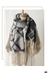 Close-up of black and grey checkered scarf with long tassels on a beige coat display