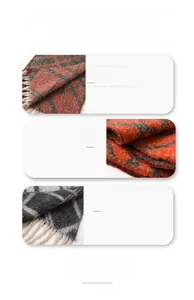 Close-up of soft plaid scarf fabric with fringe detail and high-quality woven texture