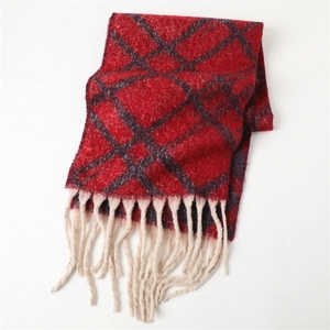 Detailed close-up of thick winter plaid scarf with red patterns and long cream tassels