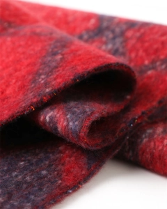 Macro shot of red and navy blue plaid scarf showing soft brushed texture and thick fabric