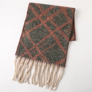 Detail of dark grey and brick red plaid scarf with thick cream tassel fringe decoration