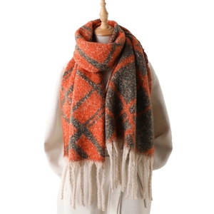 Thick plaid cashmere-like scarf with orange and grey-black patterns and long tassels