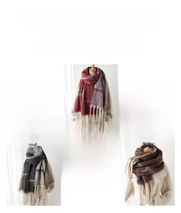 Detailed view of color-block plaid scarf texture with long fringe tassels at the edge