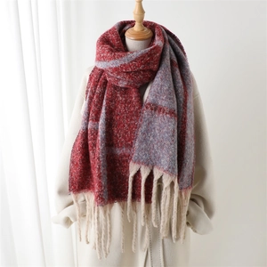 Plaid cashmere-feel winter shawl scarf with elegant tassels on a female model