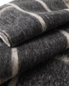 Close-up of thick grey and cream striped cashmere-like scarf with soft fuzzy texture