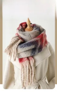 Close-up of zigzag stripe pattern and soft fringe detail on a winter cashmere-like scarf