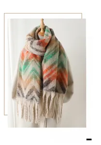 Detail shot of multicolor zigzag knit scarf with fringe trim and soft cashmere texture