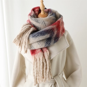 Zigzag stripe faux cashmere scarf with tassels styled on a white coat for winter fashion