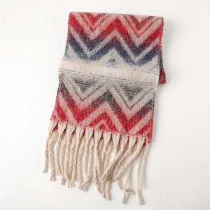 Close-up of thick chevron knit scarf texture with red, navy, and cream fringe tassels