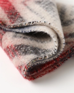 Detail of soft zigzag striped scarf fabric with colorful fringes and woven texture