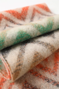 Macro shot of colorful zigzag pattern scarf with soft brushed cashmere texture and tassels