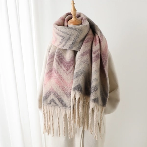 Pink and grey chevron pattern pashmina scarf with fringe on a white coat model