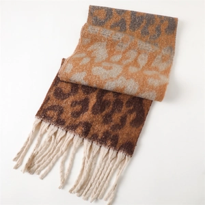 Close-up of leopard print scarf texture with dense off-white fringe tassels for winter
